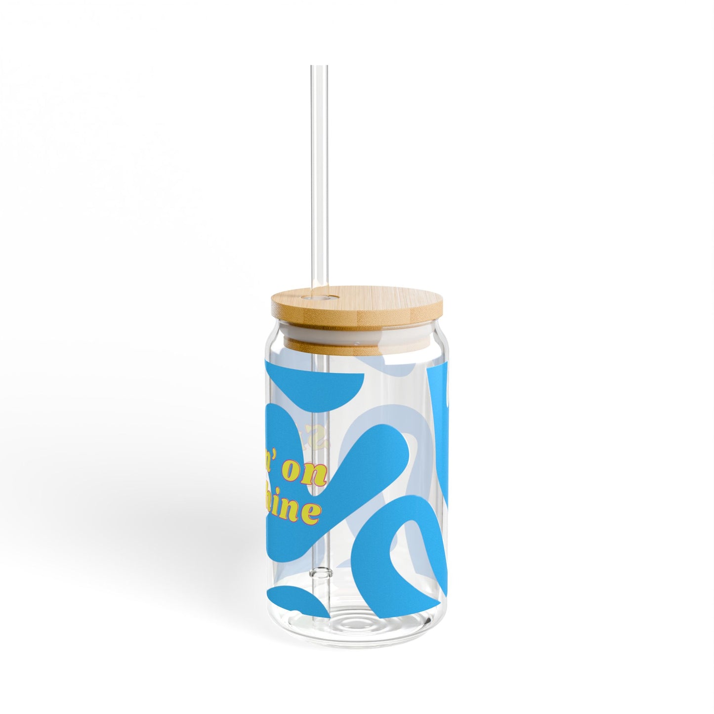 Clear tumbler with blue abstract design and wooden lid and straw