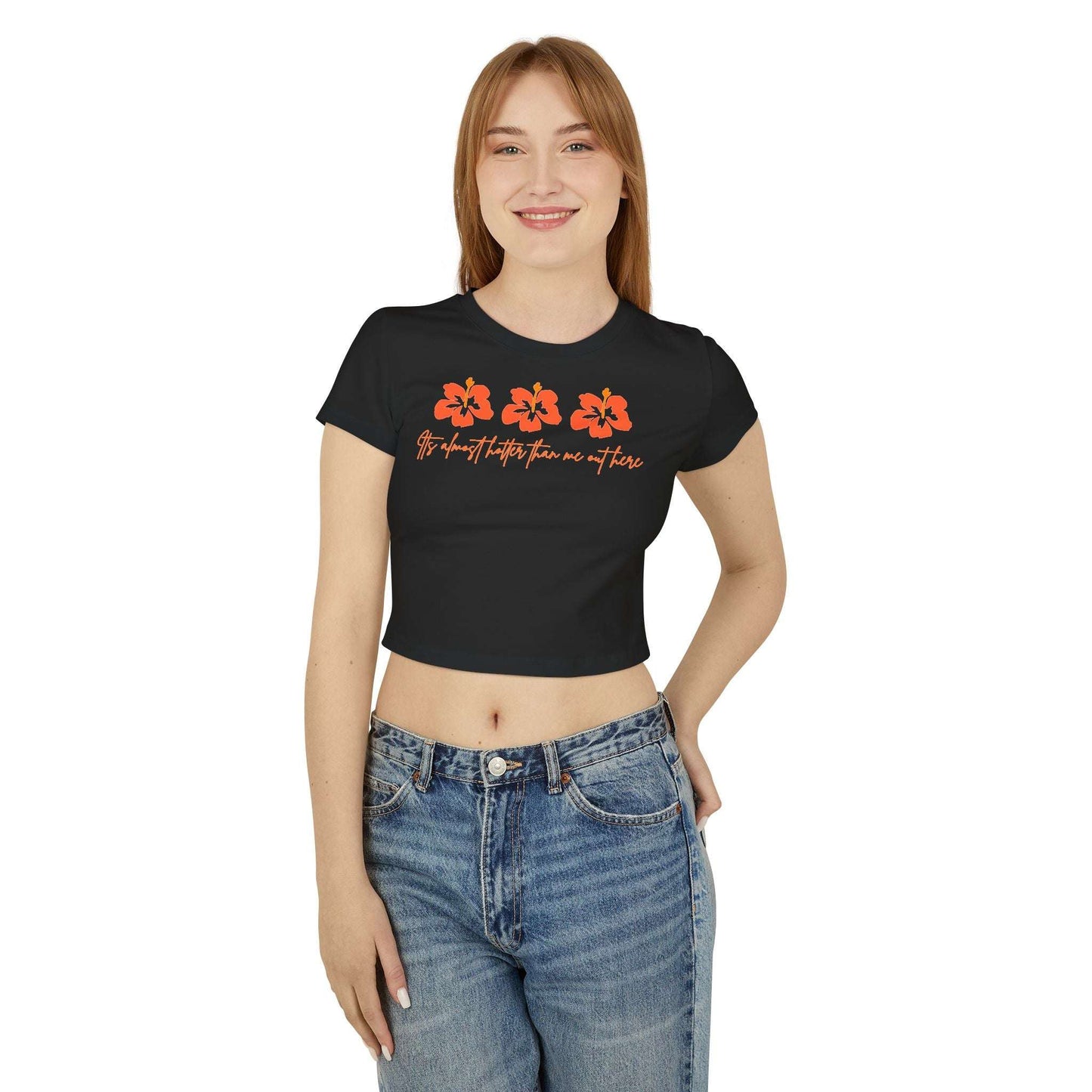 Woman wearing a black t-shirt with orange floral designs