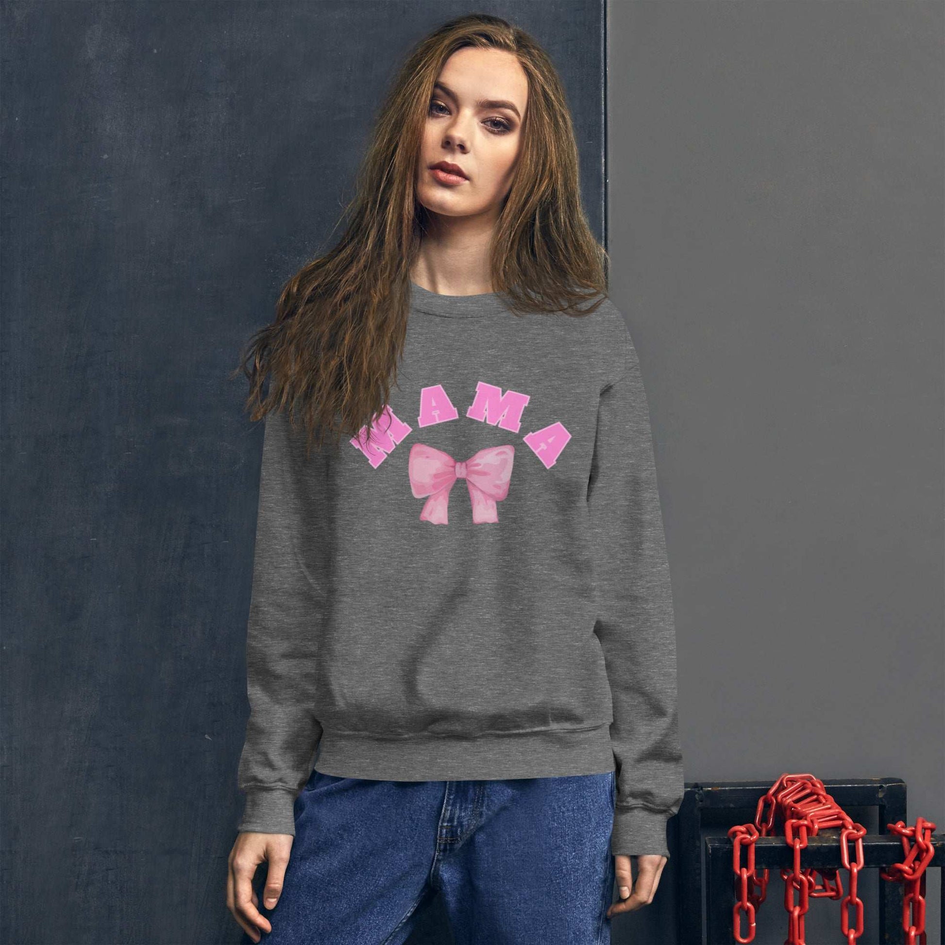 Woman wearing a gray sweatshirt with pink graphics