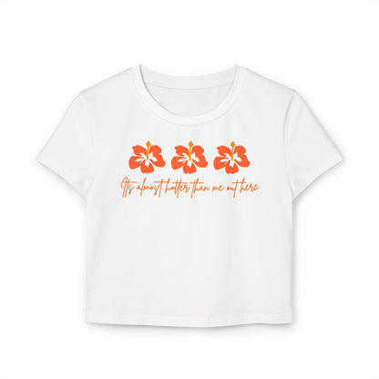 White t-shirt with orange floral designs and text
